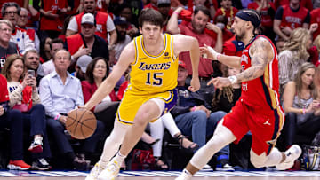 Apr 16, 2024; New Orleans, Louisiana, USA; Los Angeles Lakers guard Austin Reaves (15) dribbles against New Orleans Pelicans guard Jose Alvarado (15) during the second half of a play-in game of the 2024 NBA playoffs at Smoothie King Center. Mandatory Credit: Stephen Lew-USA TODAY Sports
