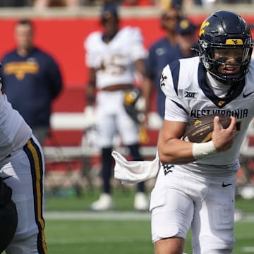 Nov 1, 2025; Houston, Texas, USA; West Virginia Mountaineers quarterback Scotty Fox Jr. (15) rushes for a touchdown against the Houston Cougars in the second half at TDECU Stadium. 