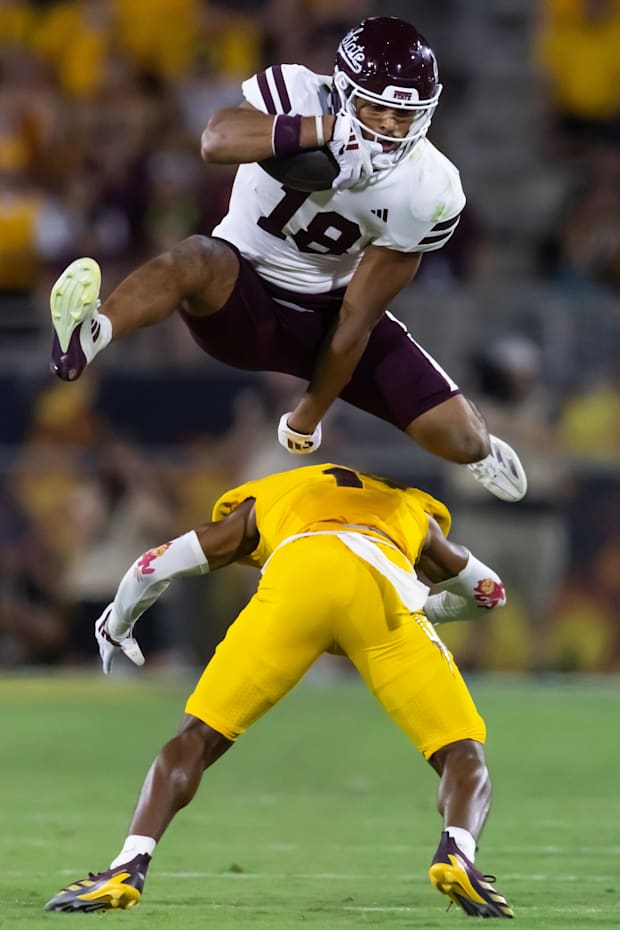 Mississippi State Bulldogs tight end Seydou Traore (18) leaps and hurdles over Arizona State Sun Devils defensive back.
