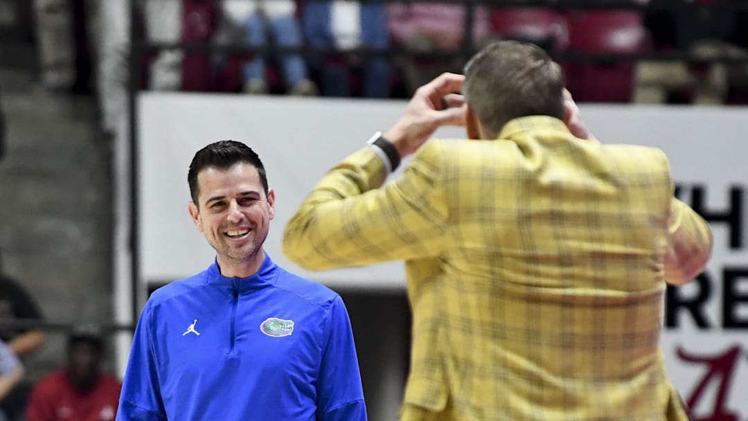 Feb 21, 2024; Tuscaloosa, Alabama, USA;  Florida Gators head coach Todd Golden laughs at Alabama Crimson Tide head coach Nate Oats as Oats reacts to an officials call at Coleman Coliseum.  Mandatory Credit: Gary Cosby Jr.-Imagn Images