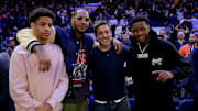 New York Knicks former player Carmelo Anthony and his son Kiyan pose for a photo with New York Jets players Aaron Rodgers