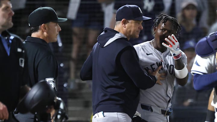 Apr 17, 2025; St. Petersburg, Florida, USA;  New York Yankees second base Jazz Chisholm Jr. (13) is ejected after he arguing as  manager Aaron Boone (17) comes out during the seventh inning against the Tampa Bay Rays at George M. Steinbrenner Field. 