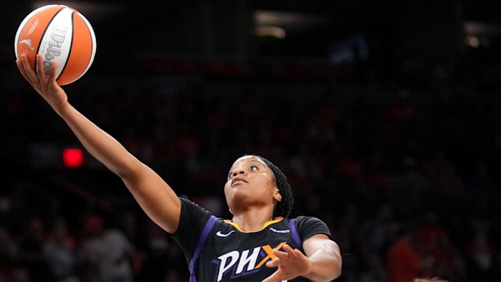 Phoenix Mercury guard Monique Akoa Makani (8) lays the ball up past Las Vegas Aces forward Kierstan Bell (1) during Game 3 of the WNBA Finals at Mortgage Matchup Center in Phoenix on Oct. 8, 2025.