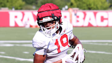 Aug 14, 2025; Fayetteville, AR, USA; Arkansas Razorbacks wide receiver Antonio Jordan (19) tucks the ball away after a catch during practice. Mandatory Credit: Nelson Chenault-Imagn Images