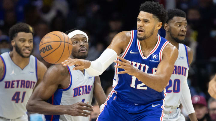 Oct 28, 2021; Philadelphia, Pennsylvania, USA; Philadelphia 76ers forward Tobias Harris (12) passes the ball past Detroit Pistons forward Jerami Grant (9) during the second quarter at Wells Fargo Center. Mandatory Credit: Bill Streicher-USA TODAY Sports