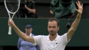 Daniil Medvedev waves to the crowd as he celebrates his win over Jannik Sinner in the quarterfinals at 2024 Wimbledon,