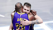 Los Angeles Lakers guard Luka Doncic (77) celebrates with Los Angeles Lakers forward LeBron James (23) during the fourth quarter against the Dallas Mavericks at American Airlines Center.