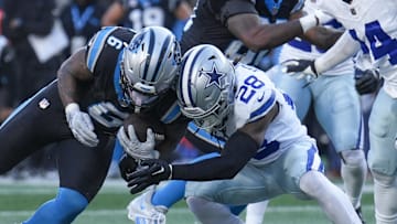 Nov 19, 2023; Charlotte, North Carolina, USA; Carolina Panthers running back Miles Sanders (6) is tackled near the goal line by Dallas Cowboys safety Malik Hooker (28) during the second half at Bank of America Stadium. Mandatory Credit: Jim Dedmon-Imagn Images