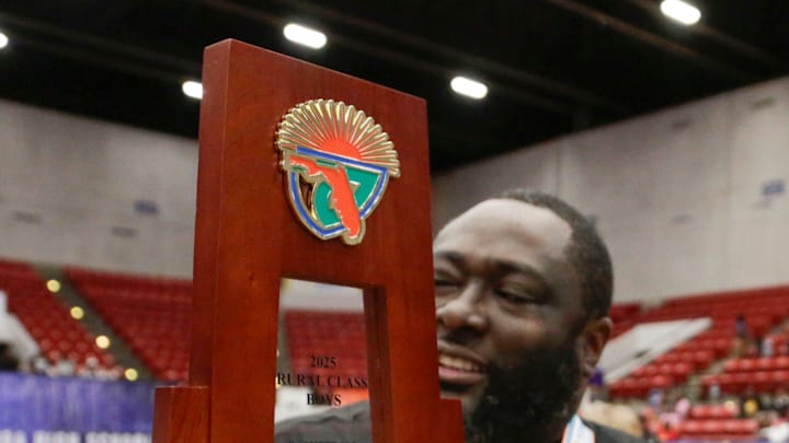 Hawthorne coach Greg Bowie and the State Trophy. Hawthorne HS defeated Crossroad Academy 59-38 in the FHSAA Rural State Boys basketball Championship game at the RP Funding Center in Lakeland Fl. February 28th 2025. Photos special to the Ledger / Calvin Knight