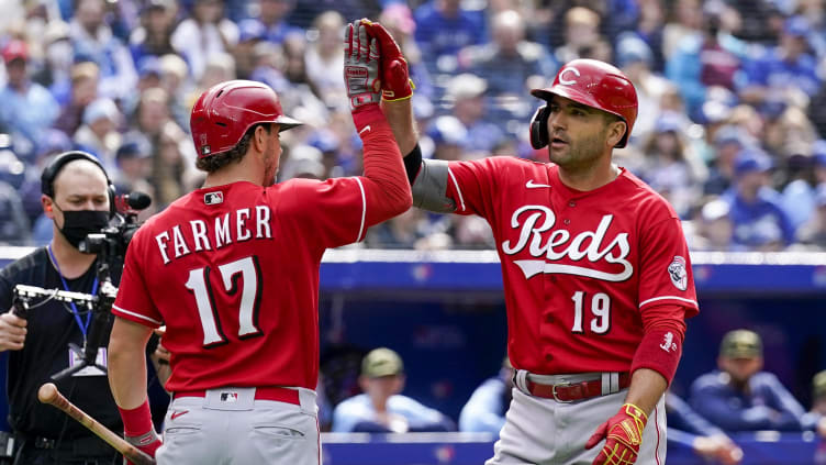 Cincinnati Reds first baseman Joey Votto (19) celebrates with Kyle Farmer.