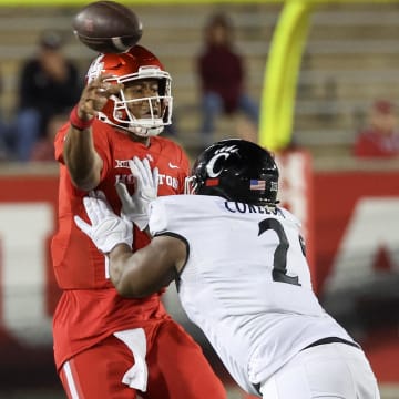 Nov 11, 2023; Houston, Texas, USA; Houston Cougars quarterback Donovan Smith (1) passes the all while being hit by Cincinnati Bearcats defensive lineman Dontay Corleone (2) in the second half at TDECU Stadium. Mandatory Credit: Thomas Shea-USA TODAY Sports