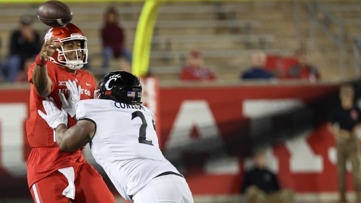 Nov 11, 2023; Houston, Texas, USA; Houston Cougars quarterback Donovan Smith (1) passes the all while being hit by Cincinnati Bearcats defensive lineman Dontay Corleone (2) in the second half at TDECU Stadium. Mandatory Credit: Thomas Shea-USA TODAY Sports