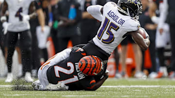 Sep 17, 2023; Cincinnati, Ohio, USA; Cincinnati Bengals cornerback Mike Hilton (21) brings down Baltimore Ravens wide receiver Nelson Agholor (15) in the second half at Paycor Stadium. Mandatory Credit: Katie Stratman-Imagn Images