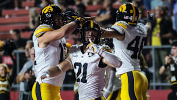 Sep 19, 2025; Piscataway, New Jersey, USA; Iowa Hawkeyes wide receiver Kaden Wetjen (21) celebrates with teammates after returning the opening kick off for a touchdown during the first quarter against the Rutgers Scarlet Knights at SHI Stadium. Mandatory Credit: Vincent Carchietta-Imagn Images