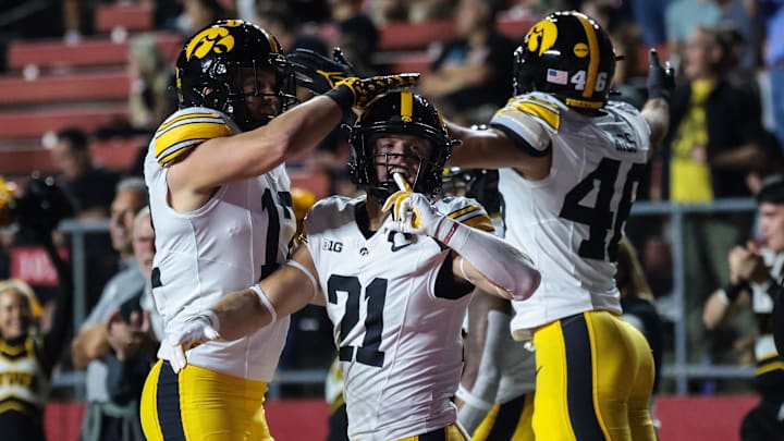 Sep 19, 2025; Piscataway, New Jersey, USA; Iowa Hawkeyes wide receiver Kaden Wetjen (21) celebrates with teammates after returning the opening kick off for a touchdown during the first quarter against the Rutgers Scarlet Knights at SHI Stadium. Mandatory Credit: Vincent Carchietta-Imagn Images