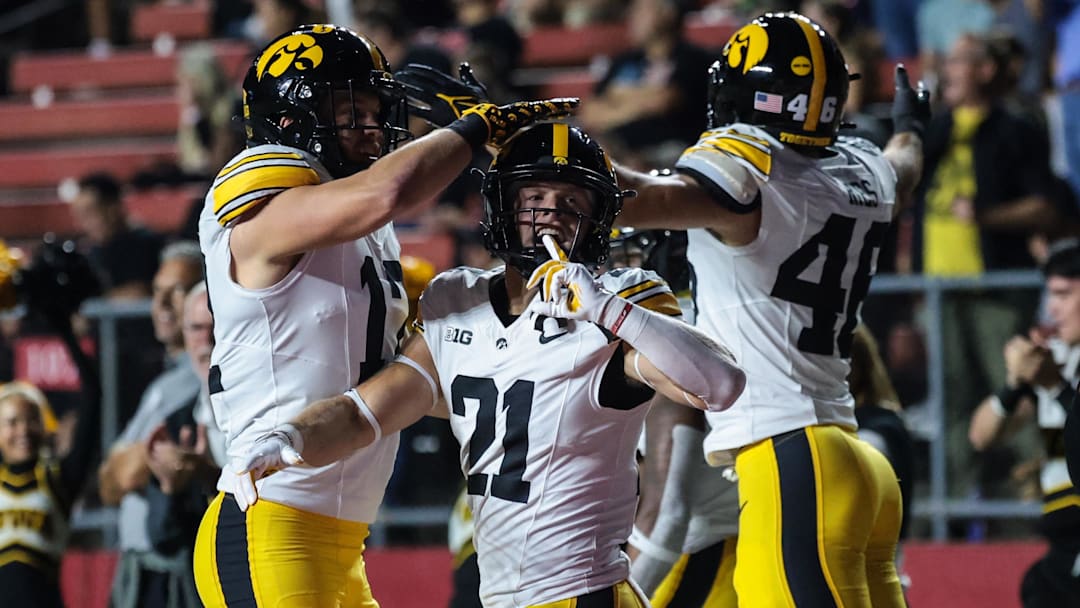 Sep 19, 2025; Piscataway, New Jersey, USA; Iowa Hawkeyes wide receiver Kaden Wetjen (21) celebrates with teammates after returning the opening kick off for a touchdown during the first quarter against the Rutgers Scarlet Knights at SHI Stadium. Mandatory Credit: Vincent Carchietta-Imagn Images