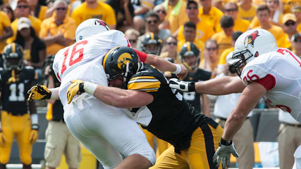 Iowa Hawkeyes defensive lineman Drew Ott (95) wraps up Illinois State Redbirds wide receiver Jon-Marc Anderson (6).