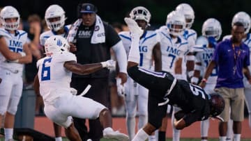 IMG's Gavin Nix (6) trips up Lipscomb's Micah Burton (15) after a catch at Lipscomb's Reese Smith Football Field in Nashville, Tenn., Friday night, Aug. 18, 2023. IMG went on to win the game 35-10.