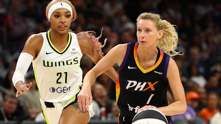 Jun 11, 2025; Phoenix, Arizona, USA; Dallas Wings guard DiJonai Carrington (21) defends against Phoenix Mercury guard Lexi Held (1) at PHX Arena. Mandatory Credit: Mark J. Rebilas-Imagn Images