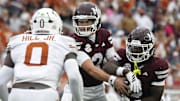 Mississippi State Bulldogs quarterback Blake Shapen (2) hands the ball off to running back Davon Booth (6) during the second quarter against the Texas Longhorns at Davis Wade Stadium at Scott Field.