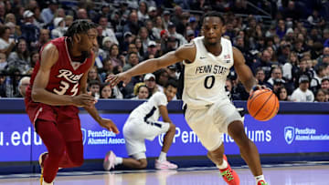 Dec 29, 2023; University Park, Pennsylvania, USA; Penn State Nittany Lions guard Kanye Clary (0) dribbles the ball towards the basket as Rider Broncs guard TJ Weeks Jr (35) defends during the first half at Bryce Jordan Center. Penn State defeated Rider 90-63. Mandatory Credit: Matthew O'Haren-Imagn Images