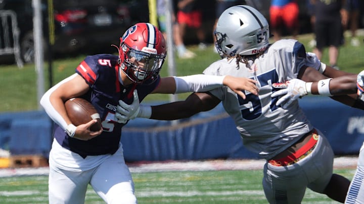 Junior quarterback Grayer Hong (5) runs the ball in Archbishop Stepinac's season opener against Lincoln on Aug. 30.