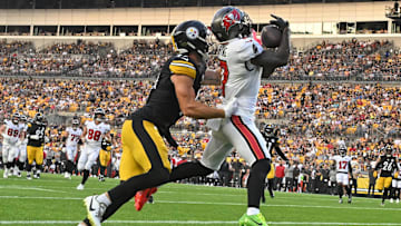 Aug 16, 2025; Pittsburgh, Pennsylvania, USA; Tampa Bay Buccaneers running back Bucky Irving (7) catches a touchdown pass in front of Pittsburgh Steelers linebacker Payton Wilson (41) during the first quarter at Acrisure Stadium. Mandatory Credit: Barry Reeger-Imagn Images