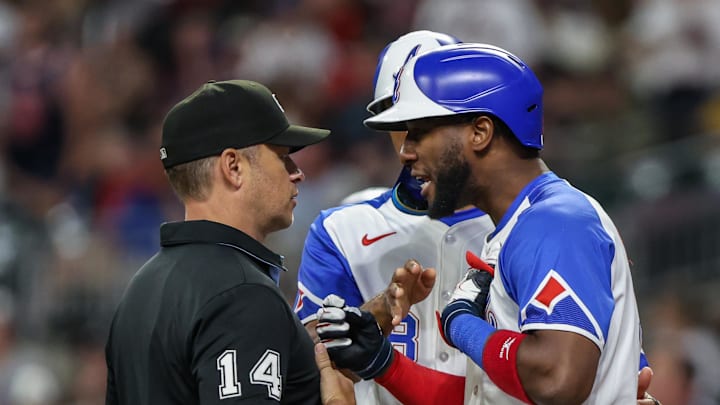 Sep 27, 2025; Cumberland, Georgia, USA; Atlanta Braves outfielder Jurickson Profar (7) speaks to umpire Mark Wegner (14) after a call in the game against the Pittsburgh Pirates during the eighth inning at Truist Park. Mandatory Credit: Jordan Godfree-Imagn Images