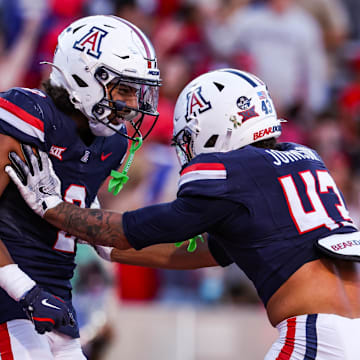 Nov 8, 2025; Tucson, Arizona, USA; Arizona Wildcats defensive backs Treydan Stukes and Dalton Johnson celebrate a win against the Kansas Jayhawks at the end of the game at Arizona Stadium. Mandatory Credit: Aryanna Frank-Imagn Images