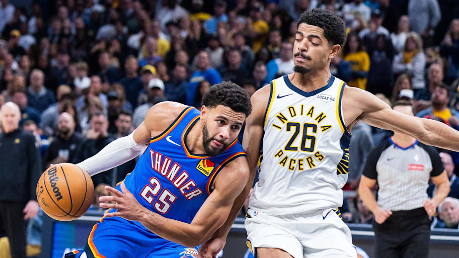Thunder guard Ajay Mitchell dribbles the ball while Pacers guard Ben Sheppard defends.