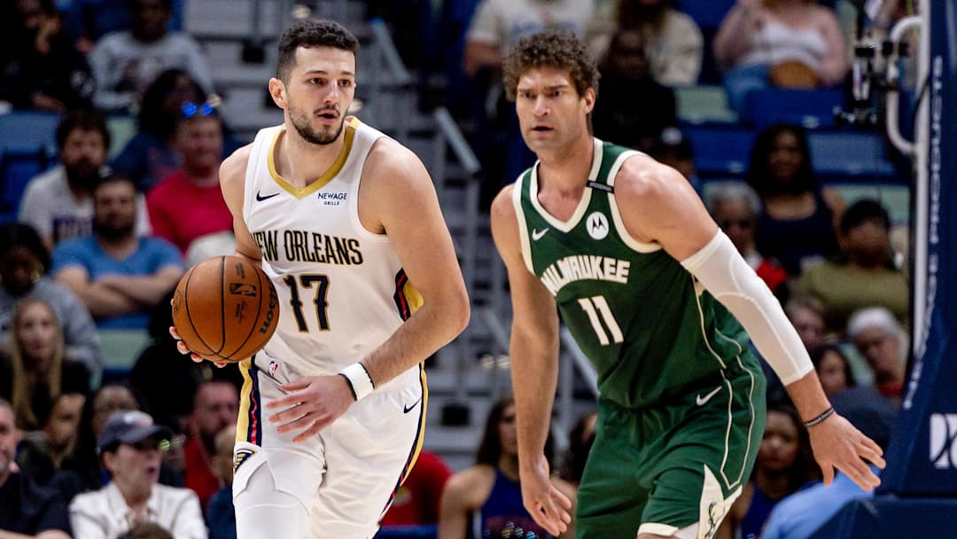 Apr 6, 2025; New Orleans, Louisiana, USA; New Orleans Pelicans center Karlo Matkovic (17) dribbles against Milwaukee Bucks center Brook Lopez (11) during the first half at Smoothie King Center. Mandatory Credit: Stephen Lew-Imagn Images