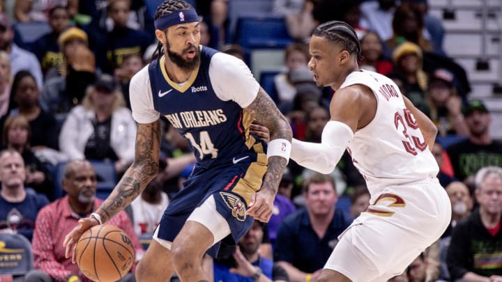 Mar 13, 2024; New Orleans, Louisiana, USA; New Orleans Pelicans forward Brandon Ingram (14) dribbles against Cleveland Cavaliers forward Isaac Okoro (35) during the first half at Smoothie King Center. Mandatory Credit: Stephen Lew-USA TODAY Sports