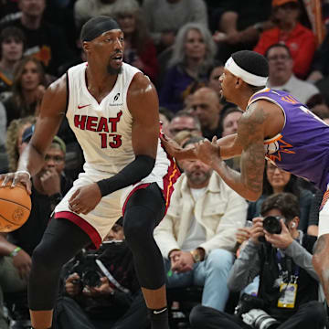 Nov 6, 2024; Phoenix, Arizona, USA; Miami Heat center Bam Adebayo (13) dribbles against Phoenix Suns guard Bradley Beal (3) during the first half at Footprint Center. Mandatory Credit: Joe Camporeale-Imagn Images