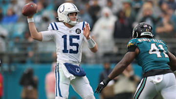 Dec 7, 2025; Jacksonville, Florida, USA; Indianapolis Colts quarterback Riley Leonard (15) looks to pass downfield Jacksonville Jaguars defensive end Josh Hines-Allen (41) defends during the first half at EverBank Stadium. Mandatory Credit: Matt Pendleton-Imagn Images