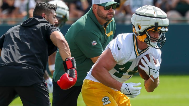 Green Bay Packers fullback Henry Pearson runs through a ball-security driill at training camp.