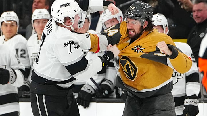 Mar 9, 2025; Las Vegas, Nevada, USA; Los Angeles Kings center Samuel Helenius (79) fights Vegas Golden Knights defenseman Nicolas Hague (14) during the second period at T-Mobile Arena. Mandatory Credit: Stephen R. Sylvanie-Imagn Images