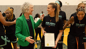Eugene Mayor Kaarin Knudson, center left, presents Sabrina Ionescu with a plaque declaring May 12 “Sabrina Ionescu Day” in Eugene.