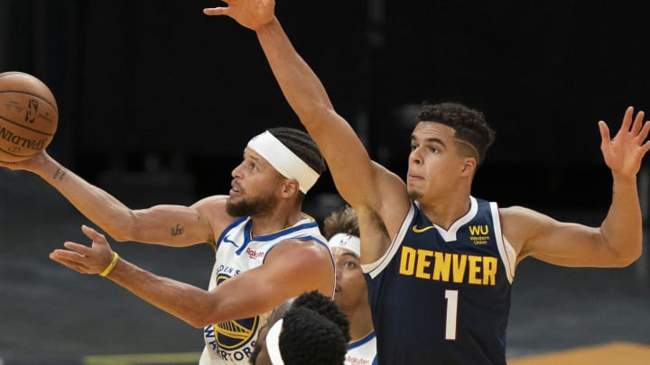 December 12, 2020; San Francisco, California, USA; Golden State Warriors guard Stephen Curry (30) shoots the basketball against Denver Nuggets forward Michael Porter Jr. (1) during the second quarter at Chase Center. 