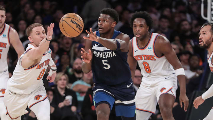 Jan 1, 2024; New York, New York, USA;  New York Knicks guard Donte DiVincenzo (0) attempts to intercept a pass made by Minnesota Timberwolves guard Anthony Edwards (5) in the fourth quarter at Madison Square Garden. Mandatory Credit: Wendell Cruz-USA TODAY Sports