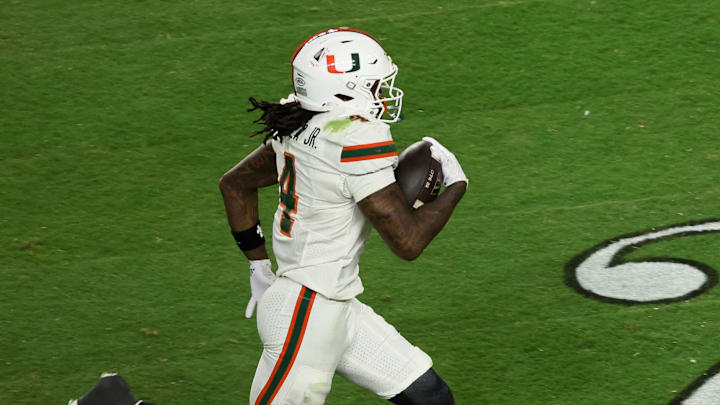 Jan 19, 2026; Miami Gardens, FL, USA; Miami Hurricanes running back Mark Fletcher Jr. (4) carries the ball for a touchdown against the Indiana Hoosiers in the third quarter during the College Football Playoff National Championship game at Hard Rock Stadium. Mandatory Credit: Kim Klement Neitzel-Imagn Images