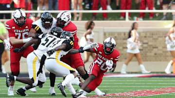 Aug 30, 2025; Lubbock, Texas, USA;  Texas Tech Red Raiders running back J’Koby Williams (20) rushes against Arkansas-Pine Bluff Golden Lions defensive safety Kyle Knox (27) in the first half at Jones AT&T Stadium. Mandatory Credit: Michael C. Johnson-Imagn Images