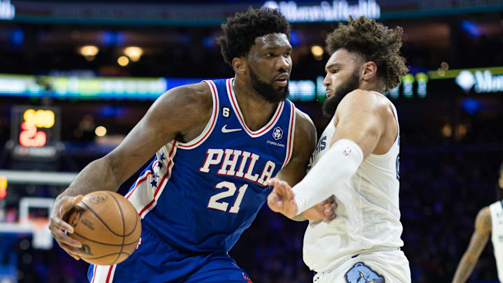 Feb 23, 2023; Philadelphia, Pennsylvania, USA; Philadelphia 76ers center Joel Embiid (21) drives against Memphis Grizzlies forward David Roddy (27) during the second quarter at Wells Fargo Center. Mandatory Credit: Bill Streicher-Imagn Images