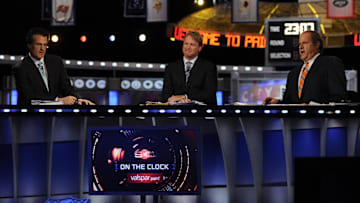 ESPN analyst Mel Kiper Jr analyst Jon Gruden  and host Chris Berman (L to R) during the 2011 NFL Draft at Radio City Music Hall. 