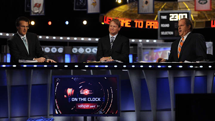 ESPN analyst Mel Kiper Jr analyst Jon Gruden  and host Chris Berman (L to R) during the 2011 NFL Draft at Radio City Music Hall. 