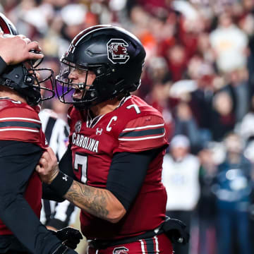 Nov 25, 2023; Columbia, South Carolina, USA; South Carolina Gamecocks quarterback Luke Doty (9) celebrates with  quarterback Spencer Rattler (7) after scoring a a touchdown against the Clemson Tigers in the second quarter at Williams-Brice Stadium. Mandatory Credit: Jeff Blake-USA TODAY Sports