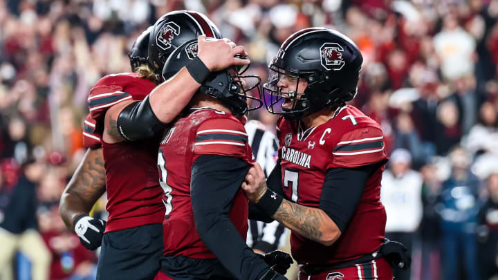 Nov 25, 2023; Columbia, South Carolina, USA; South Carolina Gamecocks quarterback Luke Doty (9) celebrates with  quarterback Spencer Rattler (7) after scoring a a touchdown against the Clemson Tigers in the second quarter at Williams-Brice Stadium. Mandatory Credit: Jeff Blake-USA TODAY Sports