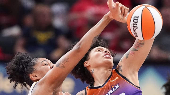 Phoenix Mercury center Brittney Griner (42) loses control of the ball against Indiana Fever forward Damiris Dantas (12) on Friday, July 12, 2024, during the game at Gainbridge Fieldhouse in Indianapolis.