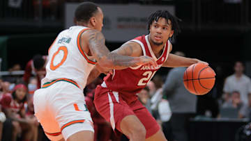Arkansas Razorbacks guard D.J. Wagner (21) protects the basketball from Miami Hurricanes guard Matthew Cleveland (0) during the first half at Watsco Center.