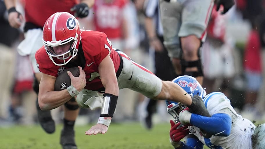 Georgia quarterback Gunner Stockton is brought down by Mississippi linebacker Suntarine Perkins.