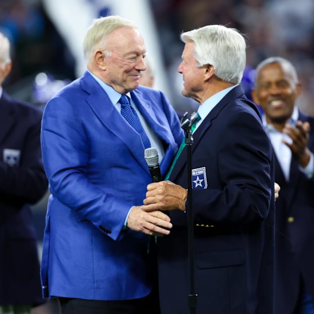 Dallas Cowboys former head coach Jimmy Johnson hugs owner Jerry Jones after being inducted into the Ring of Honor.